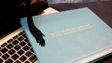 Diploma and tassel sitting on laptop